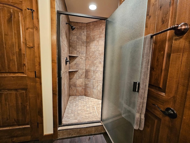 bathroom featuring a shower with door