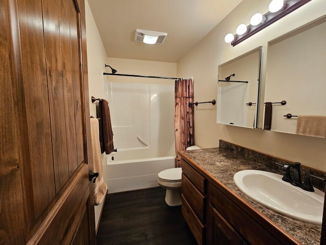 full bathroom featuring vanity, hardwood / wood-style flooring, toilet, and shower / bathtub combination with curtain