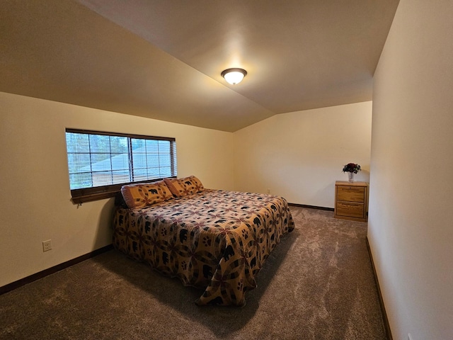 carpeted bedroom with lofted ceiling