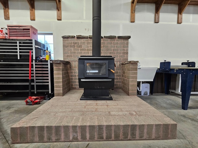 details featuring concrete floors and a wood stove