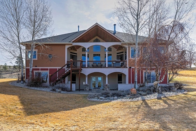 back of property featuring a patio area and a lawn