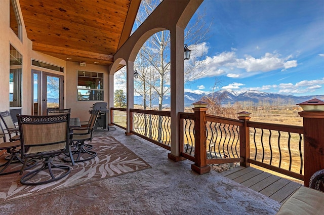 wooden terrace featuring area for grilling and a mountain view