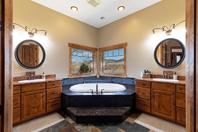 bathroom with vanity and a relaxing tiled tub