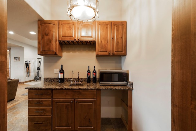 kitchen featuring sink and dark stone counters