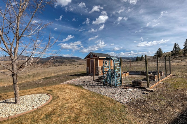 view of outdoor structure featuring a mountain view and a rural view