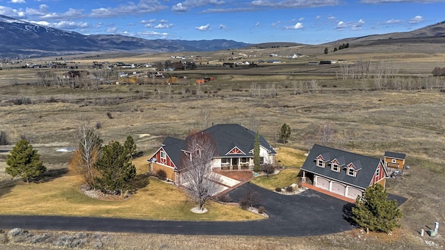 drone / aerial view featuring a mountain view and a rural view