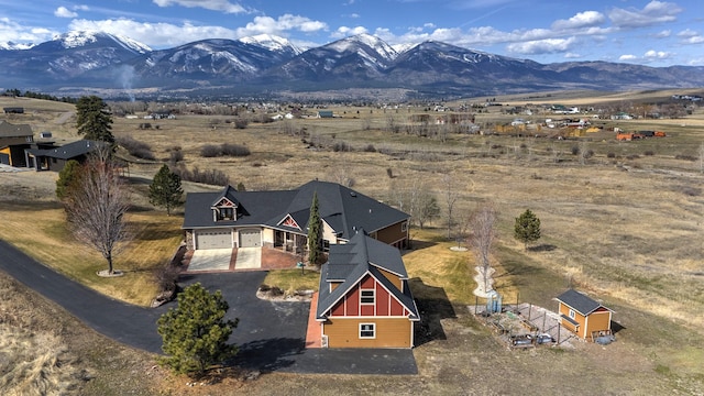 drone / aerial view featuring a mountain view and a rural view