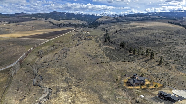 birds eye view of property featuring a mountain view and a rural view