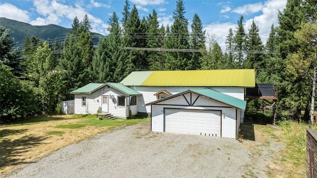 view of front of home featuring an outbuilding, a mountain view, and a garage