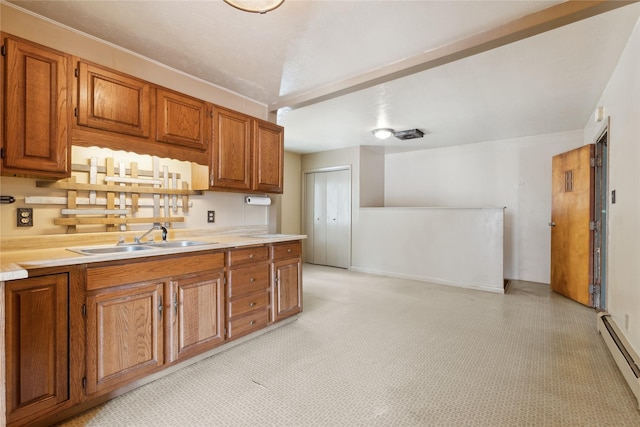 kitchen with baseboard heating and sink