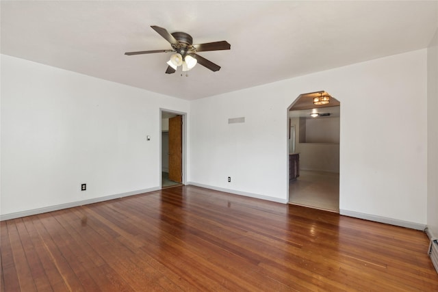 empty room with baseboard heating, ceiling fan, and dark hardwood / wood-style floors