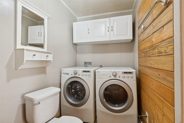 laundry room with washing machine and dryer and crown molding