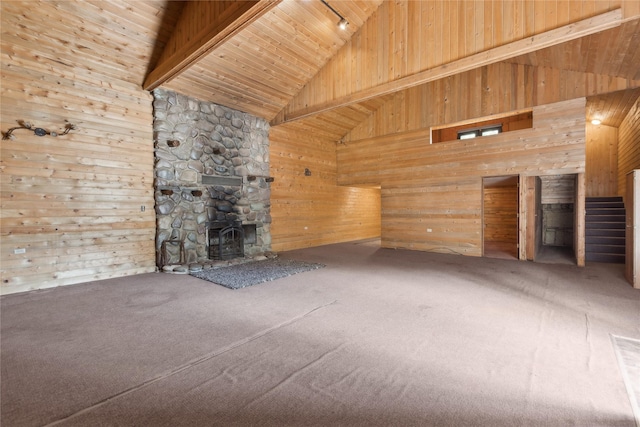 unfurnished living room featuring beam ceiling, carpet floors, high vaulted ceiling, and wood ceiling