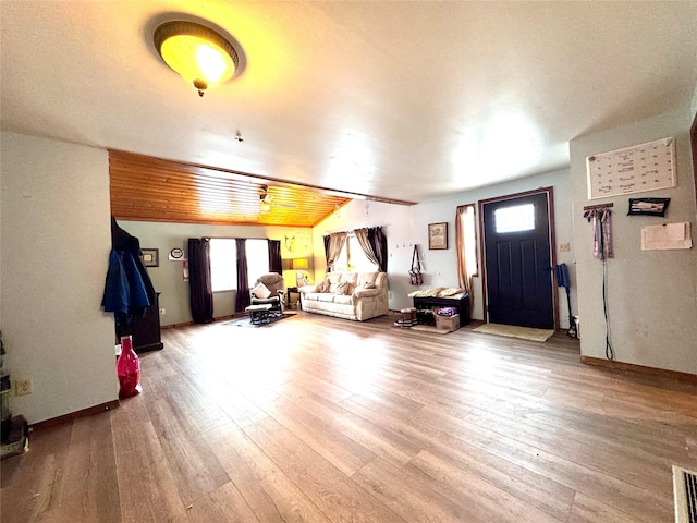 living area featuring visible vents and wood finished floors