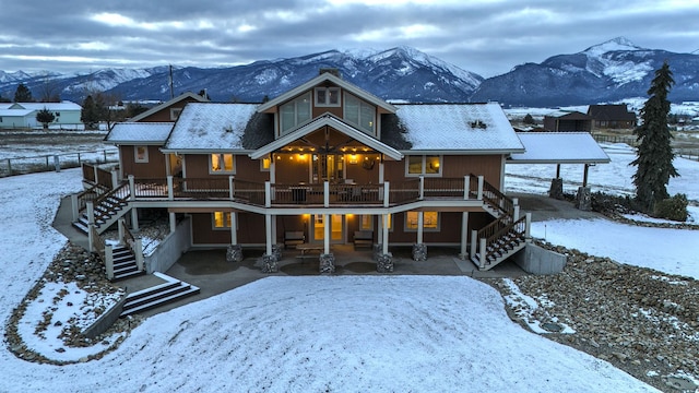 snow covered property featuring a mountain view