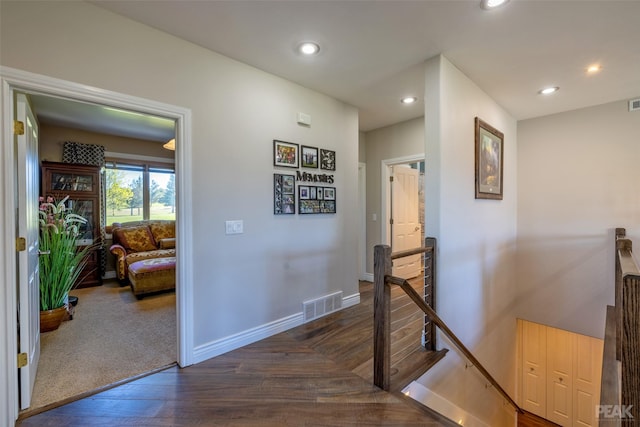 hallway with dark hardwood / wood-style flooring