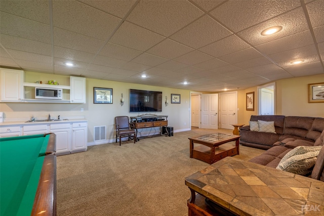 carpeted living room with sink