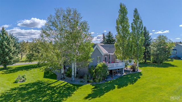 exterior space with a wooden deck and a yard