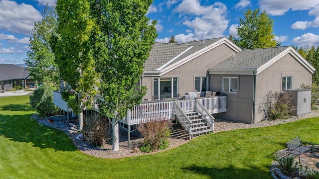 back of house featuring a lawn and a wooden deck