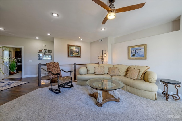 living room featuring ceiling fan and dark hardwood / wood-style flooring