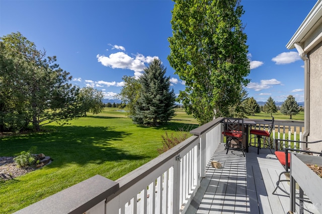 wooden deck with a lawn