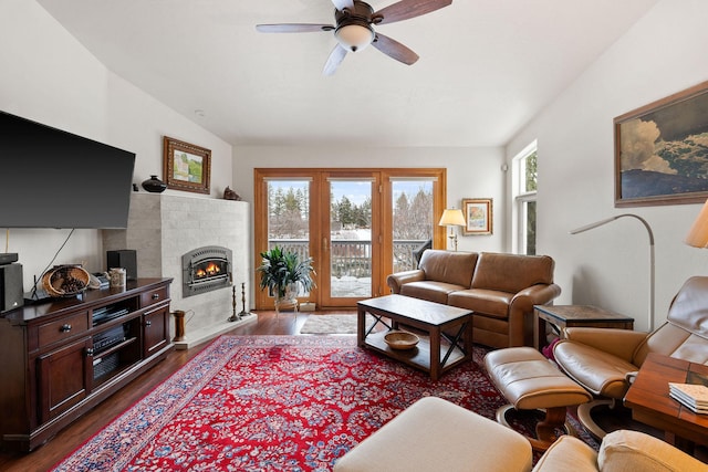 living room with hardwood / wood-style flooring, vaulted ceiling, and ceiling fan