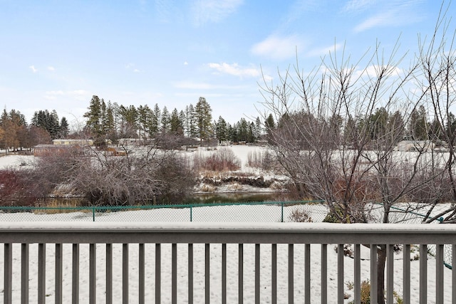 view of snow covered back of property