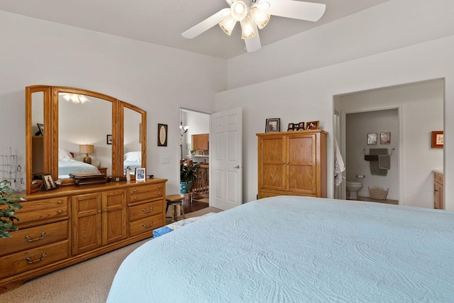 bedroom featuring light carpet, connected bathroom, and ceiling fan