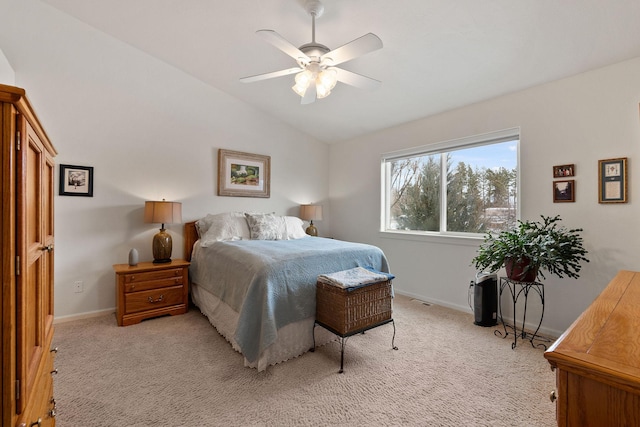 bedroom featuring ceiling fan, light colored carpet, and vaulted ceiling