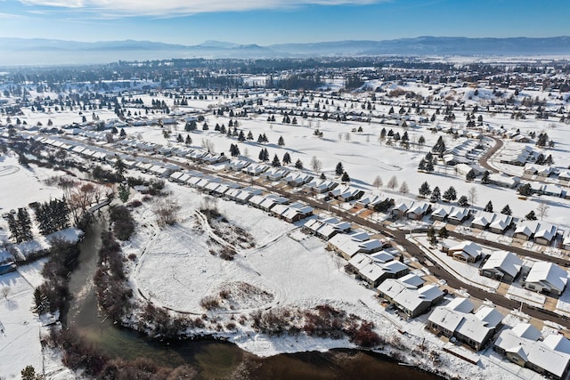 snowy aerial view with a mountain view