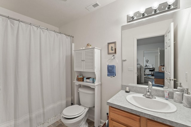 bathroom featuring vanity and toilet