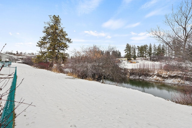 snowy yard with a water view