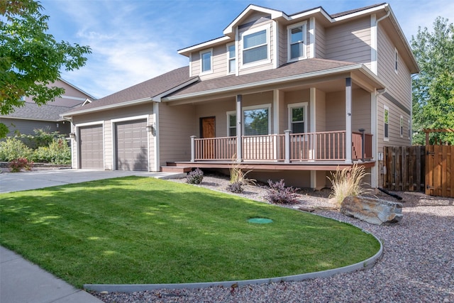 view of front of house with a front lawn, covered porch, and a garage