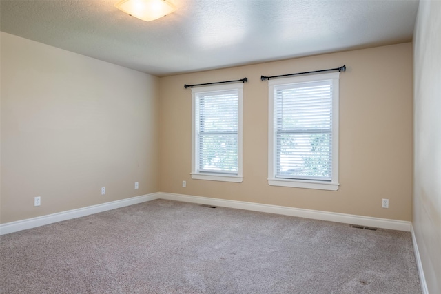 empty room featuring light carpet