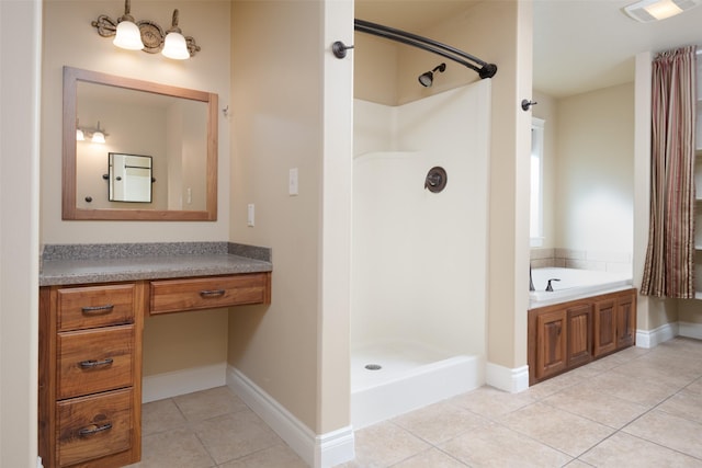 bathroom with tile patterned flooring, vanity, and separate shower and tub