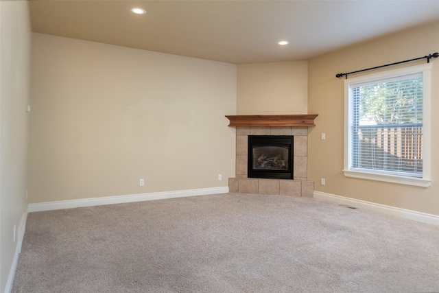 unfurnished living room featuring carpet flooring and a fireplace