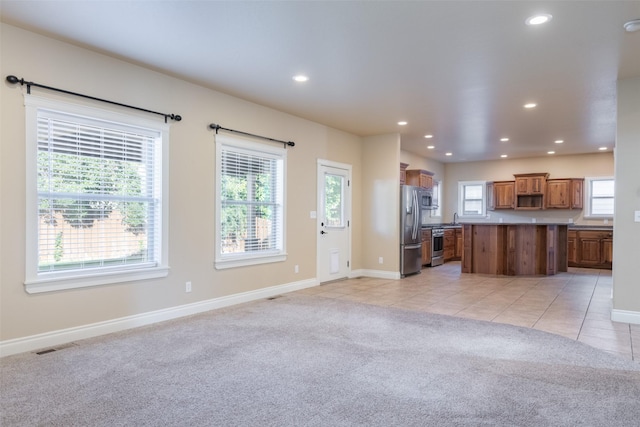 unfurnished living room with light colored carpet