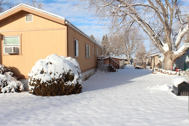 view of snowy exterior with cooling unit