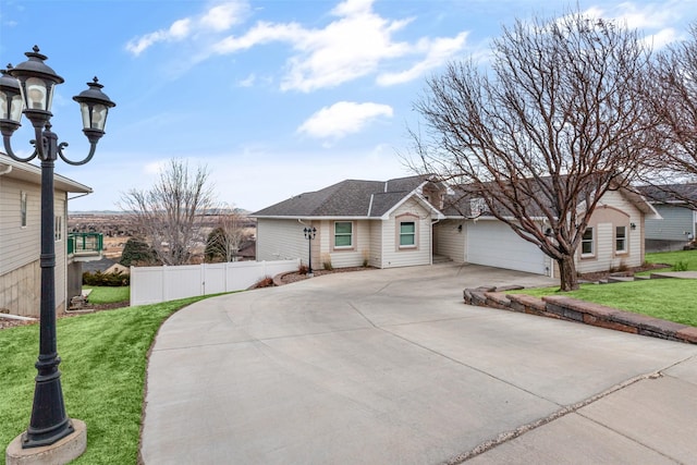 ranch-style house featuring a garage and a front lawn