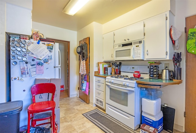 kitchen with white cabinets and white appliances