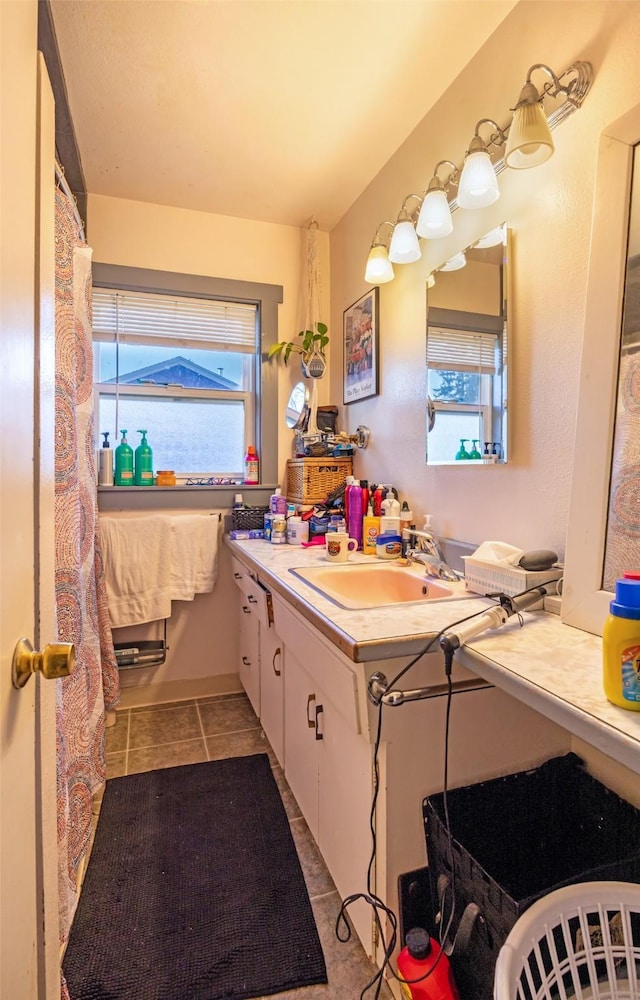 bathroom with tile patterned flooring and vanity