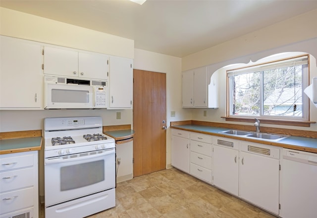 200 N Ave W, Missoula, MT 59801 - kitchen with arched walkways, white cabinetry, a sink, and white appliances