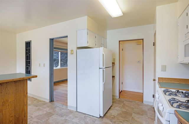 200 N Ave W, Missoula, MT 59801 - kitchen with baseboards, white cabinetry, and white appliances