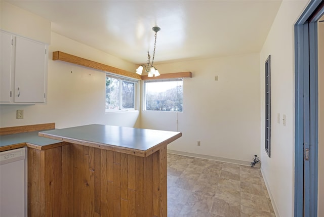 200 N Ave W, Missoula, MT 59801 - kitchen featuring white cabinets, dishwasher, pendant lighting, a peninsula, and a chandelier