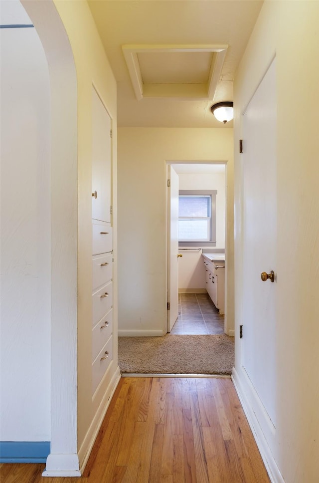 200 N Ave W, Missoula, MT 59801 - hall featuring attic access, baseboards, arched walkways, and light wood-type flooring