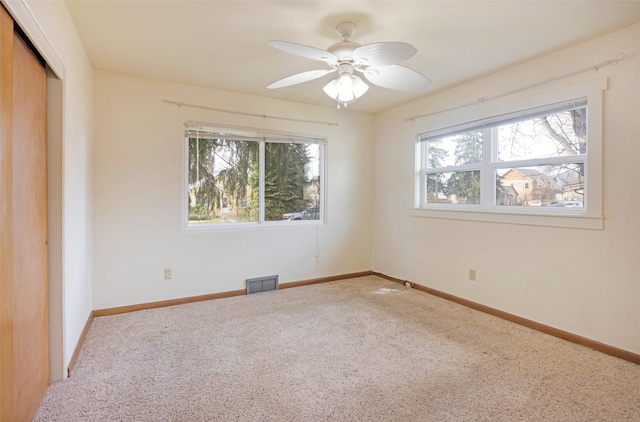 200 N Ave W, Missoula, MT 59801 - unfurnished bedroom featuring a closet, carpet, visible vents, and multiple windows