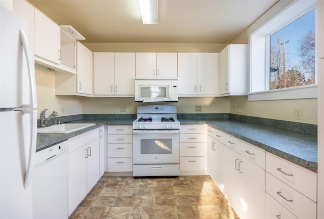 kitchen with white cabinets, white appliances, and sink