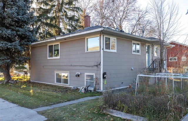 view of side of property with a yard