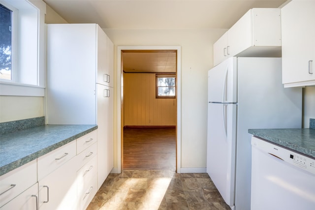 kitchen featuring white cabinets and white appliances