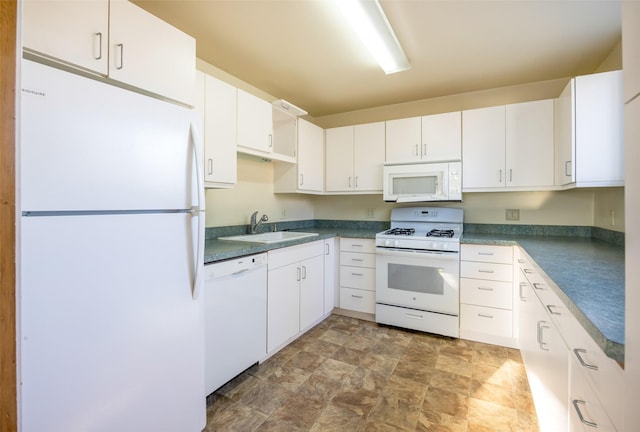 200 N Ave W, Missoula, MT 59801 - kitchen featuring white cabinets, a sink, dark countertops, white appliances, and stone finish flooring